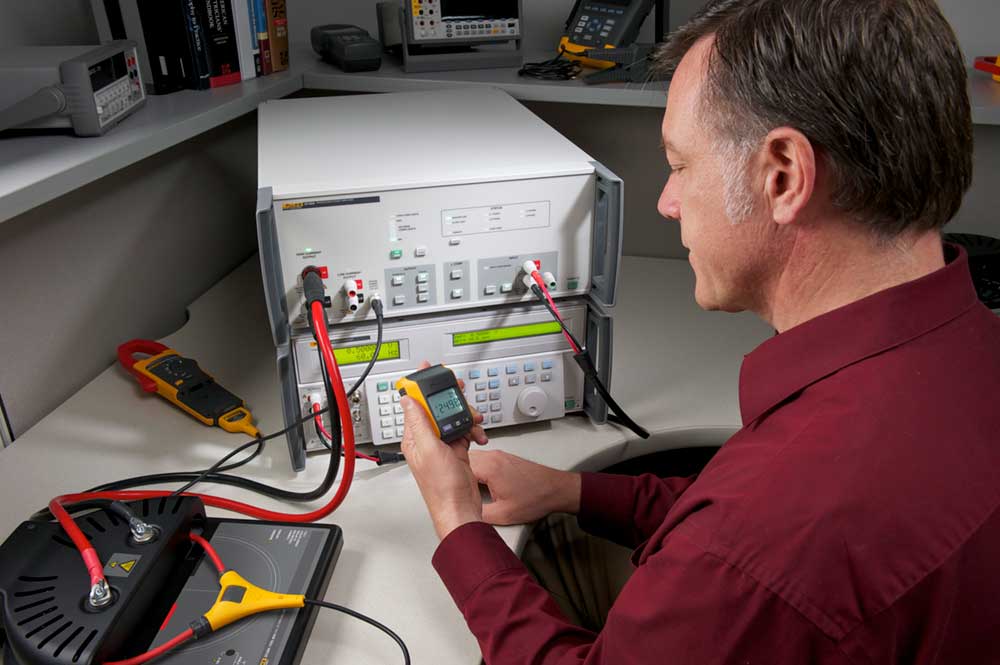 Calibration Technician Using a Transconductance Amplifier with a Fluke 381 Remote Display Clamp Meter with iFlex